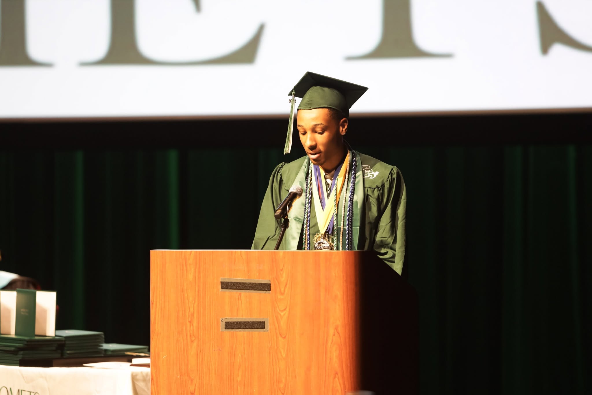 An honor graduate addresses the Comet family